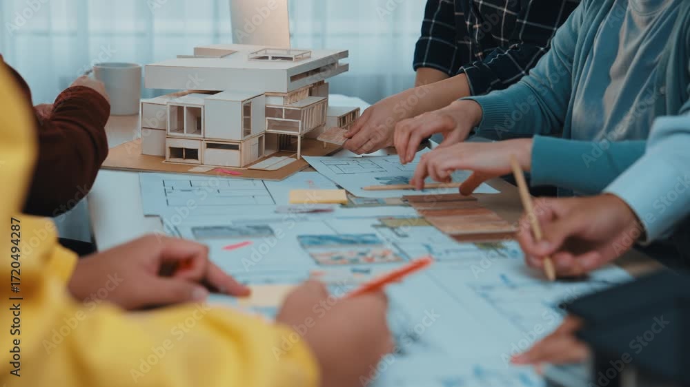 Poster A vibrant brainstorming session unfolds as architects and designers collaborate on architectural models and sketches, showcasing creativity and teamwork in a modern office environment. SACTR