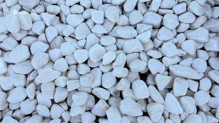 A clean and minimalist texture of smooth white pebbles