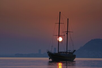 Gulet anchored in Alicante Bay, Spain, with an impressive sunset.