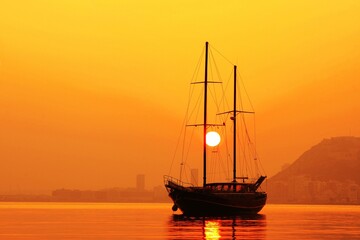 Gulet anchored in Alicante Bay, Spain, with an impressive sunset.