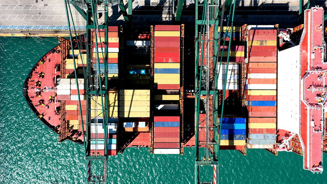 Aerial view of a container ship close to download containers in the port of Alicante, in the Mediterranean coast of Spain. - Powered by Adobe