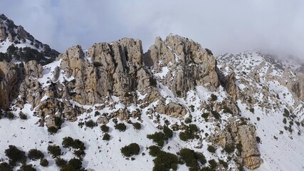 Aerial view of heavy snowfall over the mountains of the village of Castell de Castells in the province of Alicante, Spain.