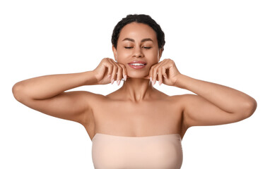 Obraz premium Young African-American woman doing face building exercise on white background