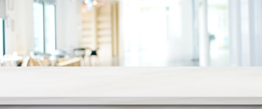 Empty white marble table over blur office background, Stone desk for product display mock up template banner, white background
