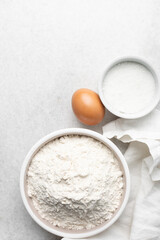 Overhead view of mise en place of ingredients used to make tart shell dough, top view of items used to make pie crust dough