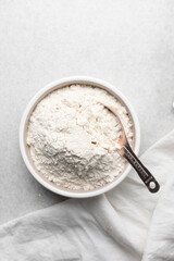 overhead view of All purpose flour in a bowl, top view of baking flour in a ceramic bowl