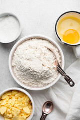 Overhead view of mise en place of ingredients used to make tart shell dough, top view of items used to make pie crust dough