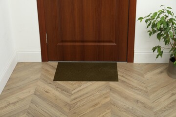 New clean green mat near entrance door