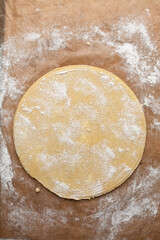overhead view of tart shell dough rolled out, top view of rolled pie shell dough