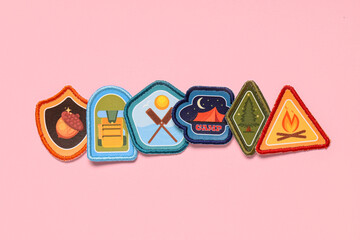 Set of scout badges on pink background