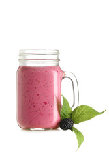 Mason jar of fresh blackberry smoothie and berry on white background