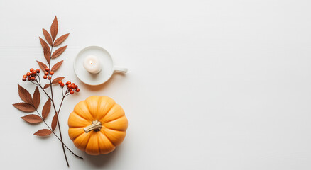 Festive autumn still life with pumpkin, candle, berries, and leaves. Perfect for fall themed designs for thanksgiving, halloween, and harvest.