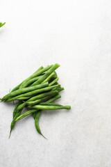 Overhead view of green beans on a marble countertop, top view of green beans, haricot verts on a white countertop