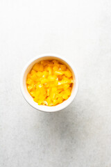 Overhead view of sliced yellow bell peppers on a marble countertop, top view of diced yellow bell peppers