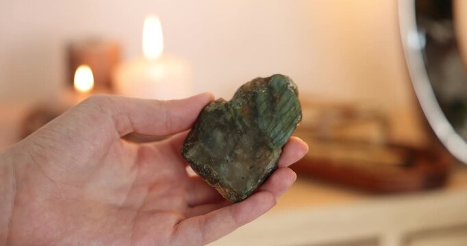 Woman with beautiful labradorite gemstone indoors, closeup