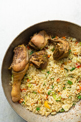 overhead view of nigerian fried rice and chicken in a pot, top view of traditional Nigerian fried rice