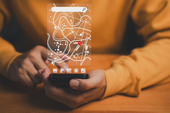 Man using a smartphone with a futuristic digital map interface showing a red location pin, representing online navigation, GPS tracking, digital maps and real-time geolocation technology.
