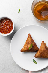 Overhead view of samosa on a white plate, top view of beef samosa on a white background