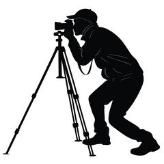 Photographer crouching with tripod silhouette