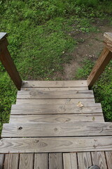 Obraz premium Steep view down wooden outdoor steps descending vertical photo