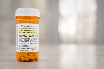 Acetaminophen Prescription Medicine Bottle Resting On A Bathroom Countertop. The label is...
