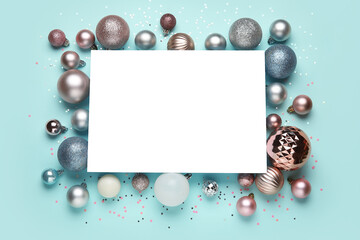 Composition with blank card, Christmas balls and confetti on blue background
