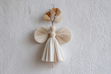 straw angel stands gracefully against pristine white wall its texture and form captivating viewer