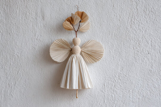 straw angel stands gracefully against pristine white wall its texture and form captivating viewer