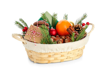 Wicker gift basket with products and beautiful Christmas decor isolated on white background