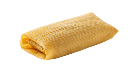 Close up of a single tamale golden yellow color wrapped in corn husk ready to eat.