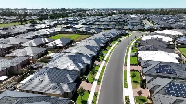 Aerial view of a suburban residential neighborhood in Stockton, California, showcasing rows of single-family homes, streets, and surrounding farmland. Ideal for topics related to urban planning, Calif