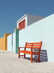 Bright-colored, modern street scene showing an orange wooden bench in front of pastel walls, against a clear blue sky in the midday sun