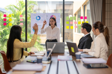 Businesswoman using diagrams and charts during a presentation in a meeting room