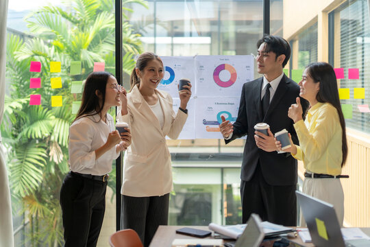 Business team celebrating successful results during coffee break