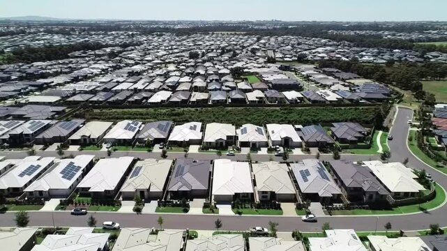 Aerial view of a suburban residential neighborhood in Stockton, California, showcasing rows of single-family homes, streets, and surrounding farmland. Ideal for topics related to urban planning, Calif