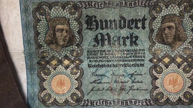 Old German banknotes offer insight into history with a 100 mark Reichsmark note. Suitable for historical articles, educational materials, and vintage design projects.