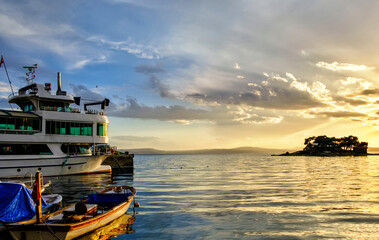 Erdek, Turkey - February 8, 2024 : Erdek Town harbor with ships at sunset