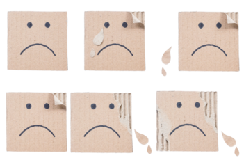 Set collection or collage of hand drawn sad face on a ripped corrugated cardboard box isolated on transparent background