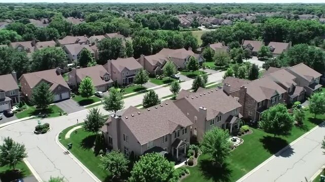 Aerial view of a suburban residential neighborhood in Stockton, California, showcasing rows of single-family homes, streets, and surrounding farmland. Ideal for topics related to urban planning, Calif