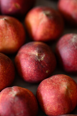 Beautiful tasty fresh peaches laying out on a table with bright red, orange and peach colors.