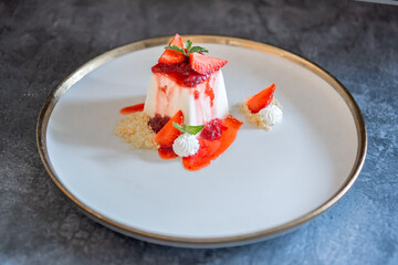 Elegant Panna Cotta Dessert with Fresh Strawberries and Cream
