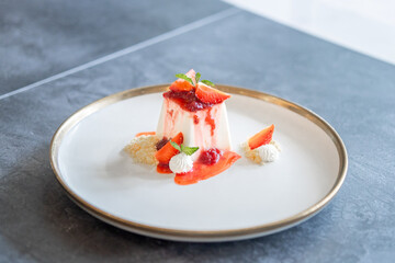 Elegant Panna Cotta Dessert with Fresh Strawberries and Cream