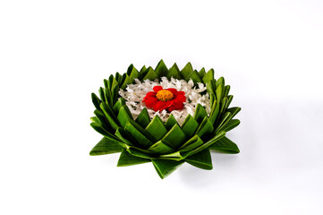 Banana leaf Krathong decorates with colorful flowers for Thailand full moon or Loy Krathong festival isolated on white paper background.