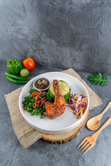 Indonesian Nasi Kuning with Fried Chicken, Vegetables, and Sambal