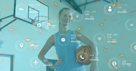 Female athlete holding basketball in gym, generating technology icons showing progress around her - Powered by Adobe