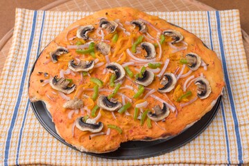 Home made Pizza with spicy capsicum cream cheese onion capsicum and mushrooms