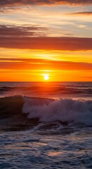 Obraz premium A vibrant sunrise paints the ocean with hues of orange and gold, showcasing powerful waves crashing against the shore.