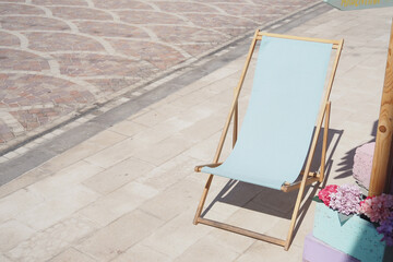 Lone beach chair on a sunny day in a coastal town