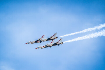 Air show planes flying in formation in blue sky