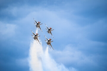 Air show planes flying in formation in blue sky